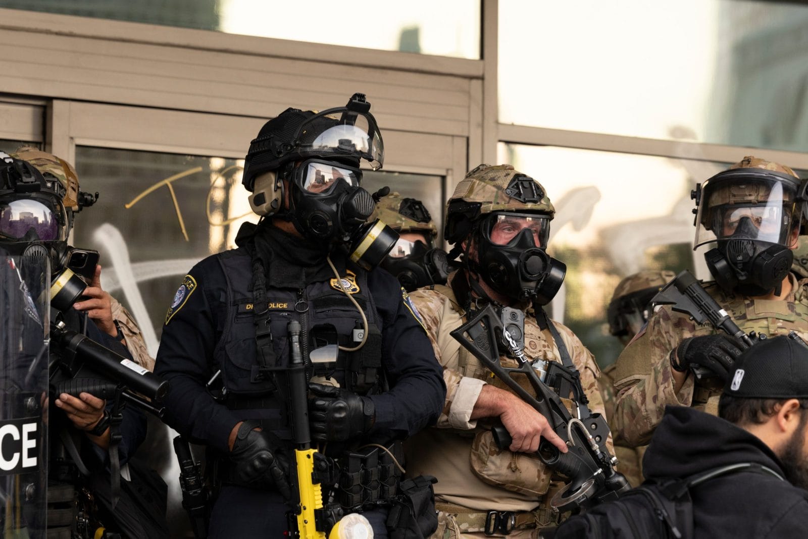 Los Angeles, California, USA - June 10, 2025: U.S. Customs and Border Protection (CBP) field officers in gas masks guard a federal building during ICE deportation protests in Downtown LA.